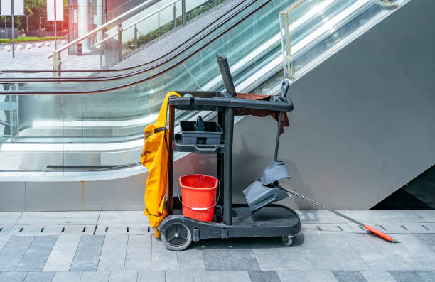 Cleaner cart in a public place with cleaning products: mop, buckets for cleaning the floor.