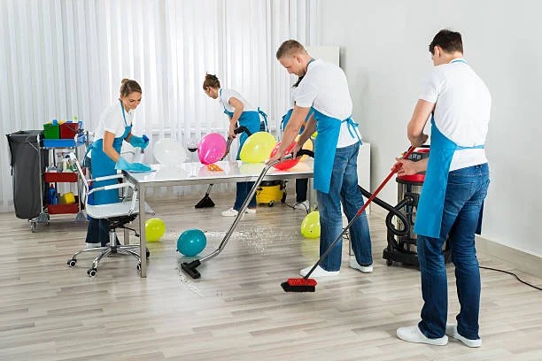 Professional cleaners performing post-event cleaning in Greenacre venue.
