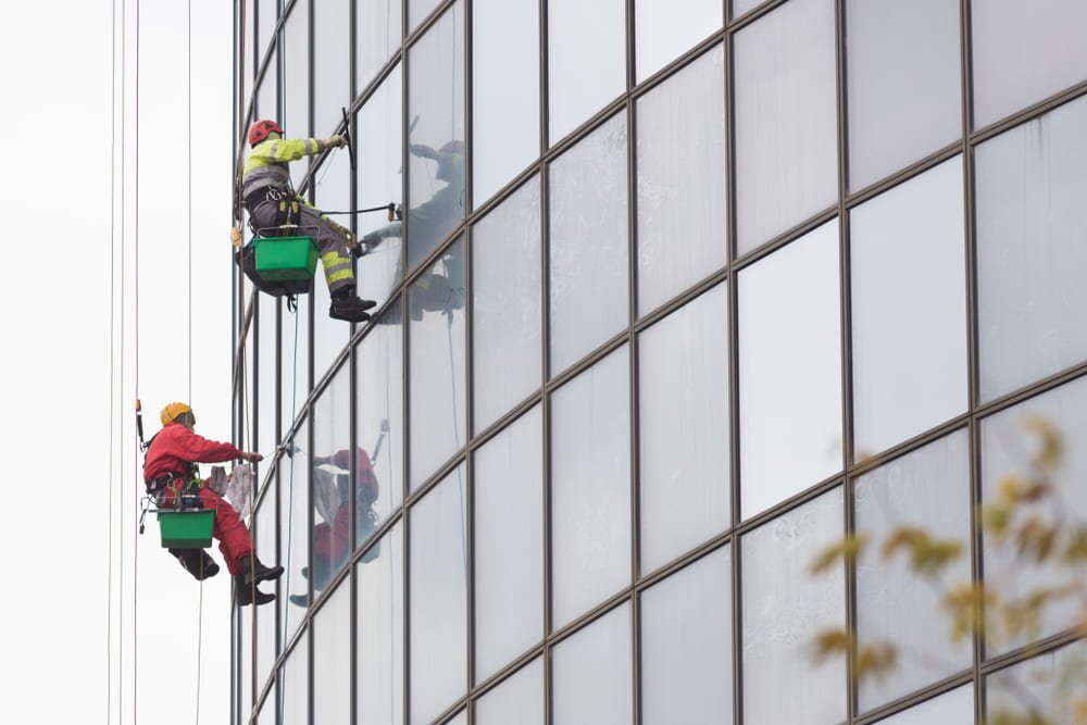 Workers cleaning high-rise building windows