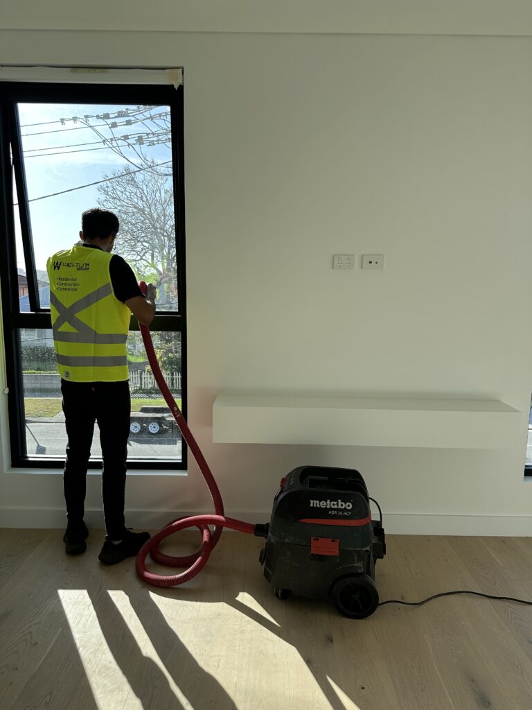 Professional cleaner providing commercial cleaning services in Barden Ridge using vacuum equipment inside a modern office space.