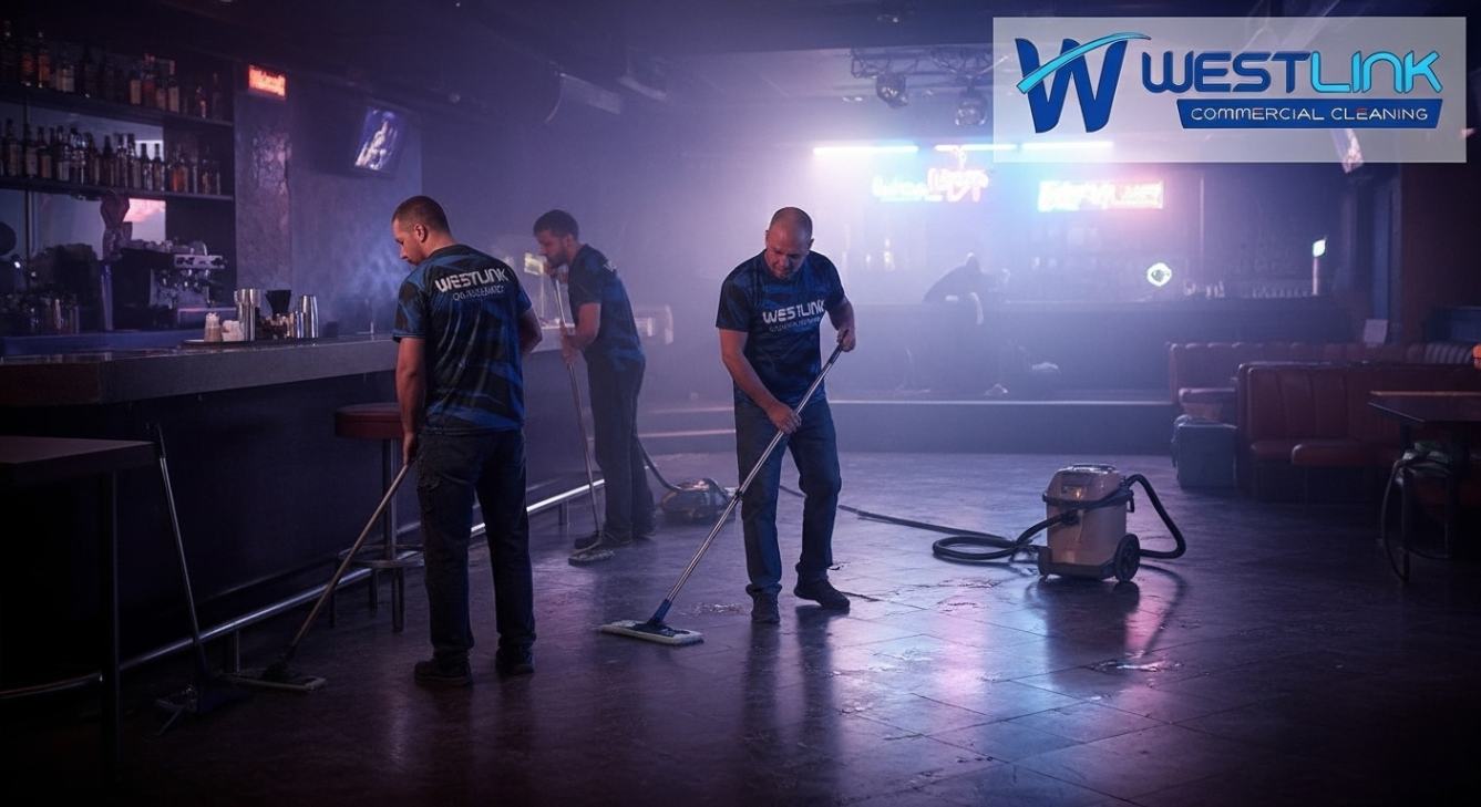 Professional cleaners performing deep nightclub cleaning under neon lights, polishing dance floors and bar surfaces, with branded uniforms.