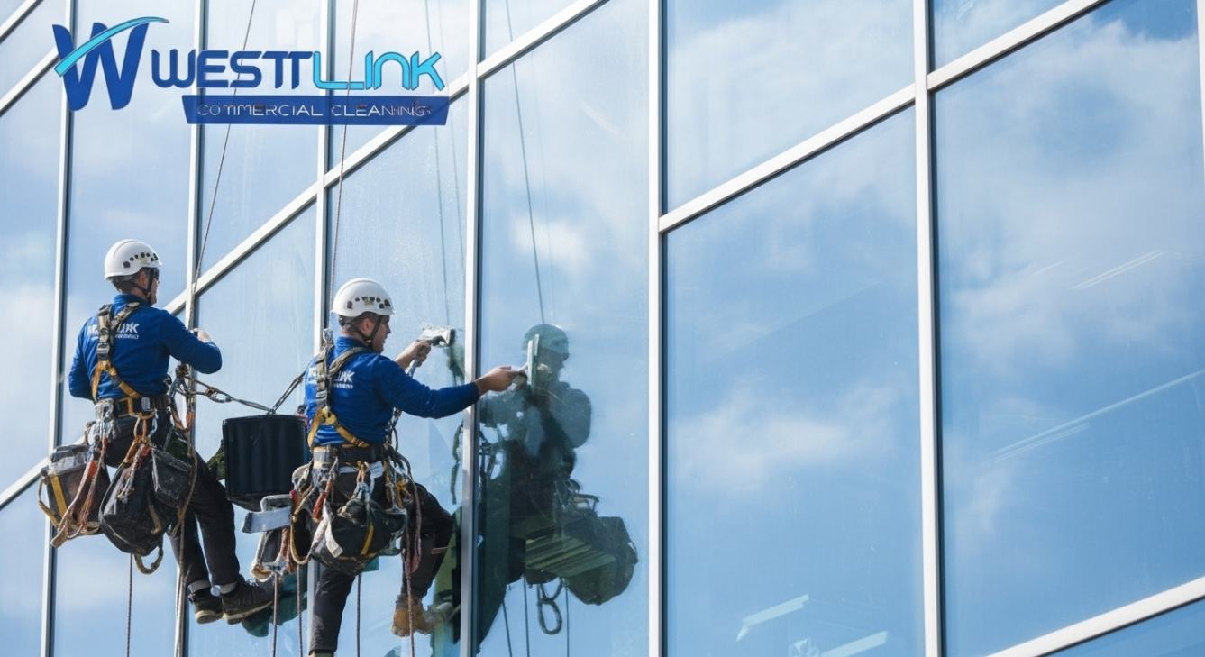 High-rise commercial window cleaning team using professional equipment and safety harnesses.