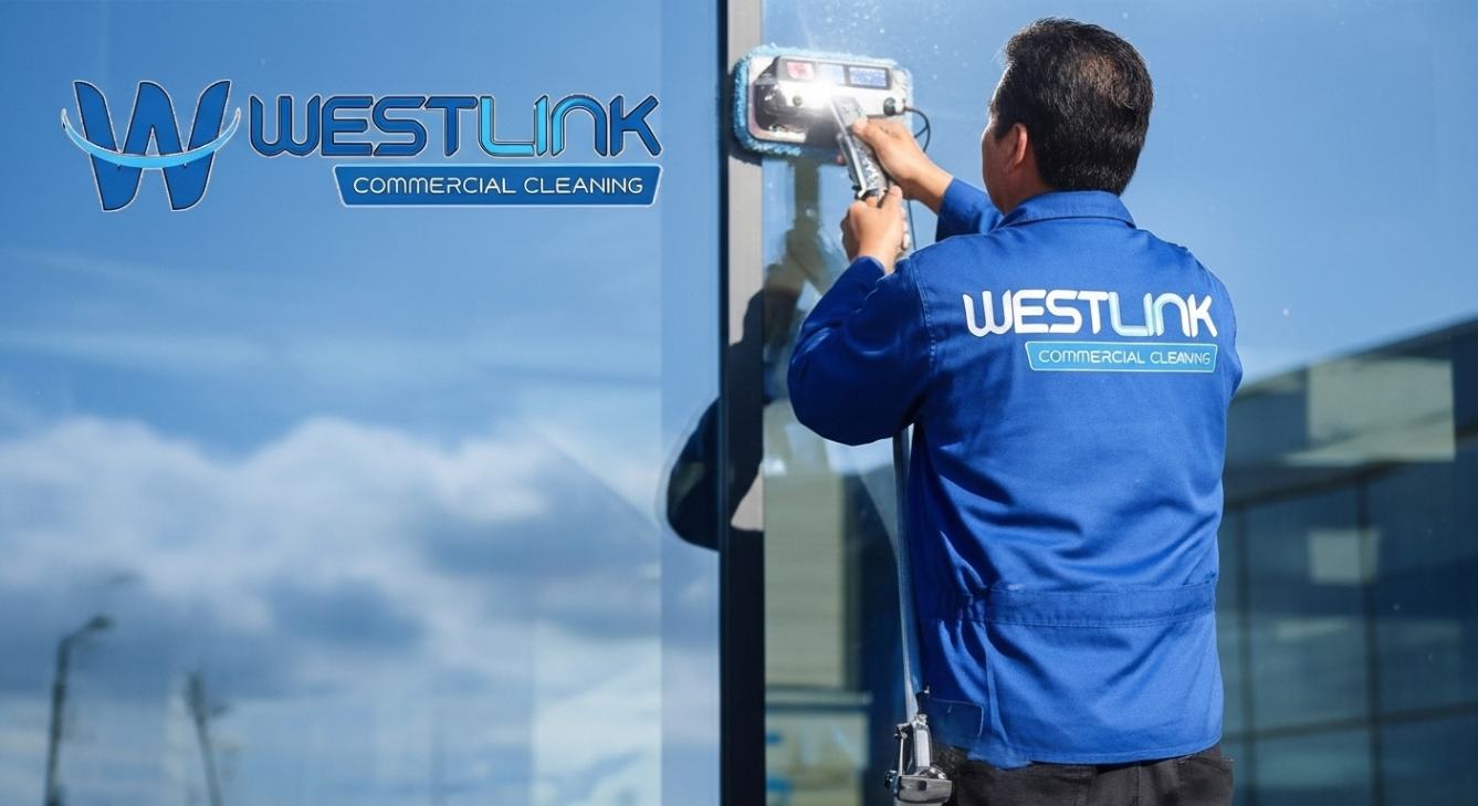 Commercial window cleaner working on a glazed building in daylight