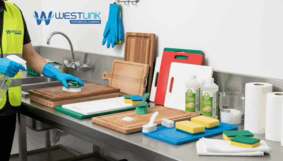 Kitchen workstation with cutting boards and cleaning tools.