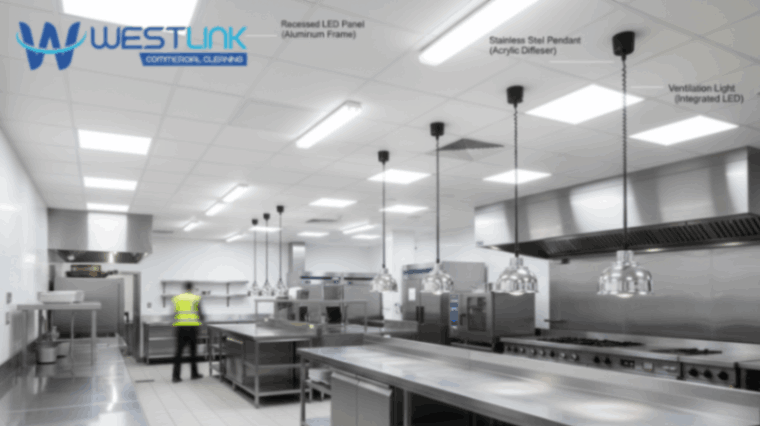 Modern commercial kitchen showing various ceiling lights and ventilation fixtures.