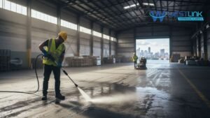 Warehouse floor being deep-cleaned with high-pressure water.