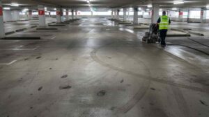 Cleaning of multi-storey car park concrete to remove oil, rubber marks, and dirt across multiple levels