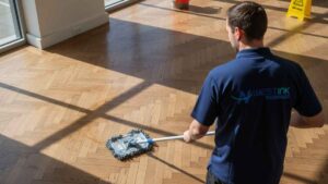 Close-up of parquet wood flooring with intricate patterns, emphasizing the need for careful multi-directional cleaning to protect the delicate wood.
