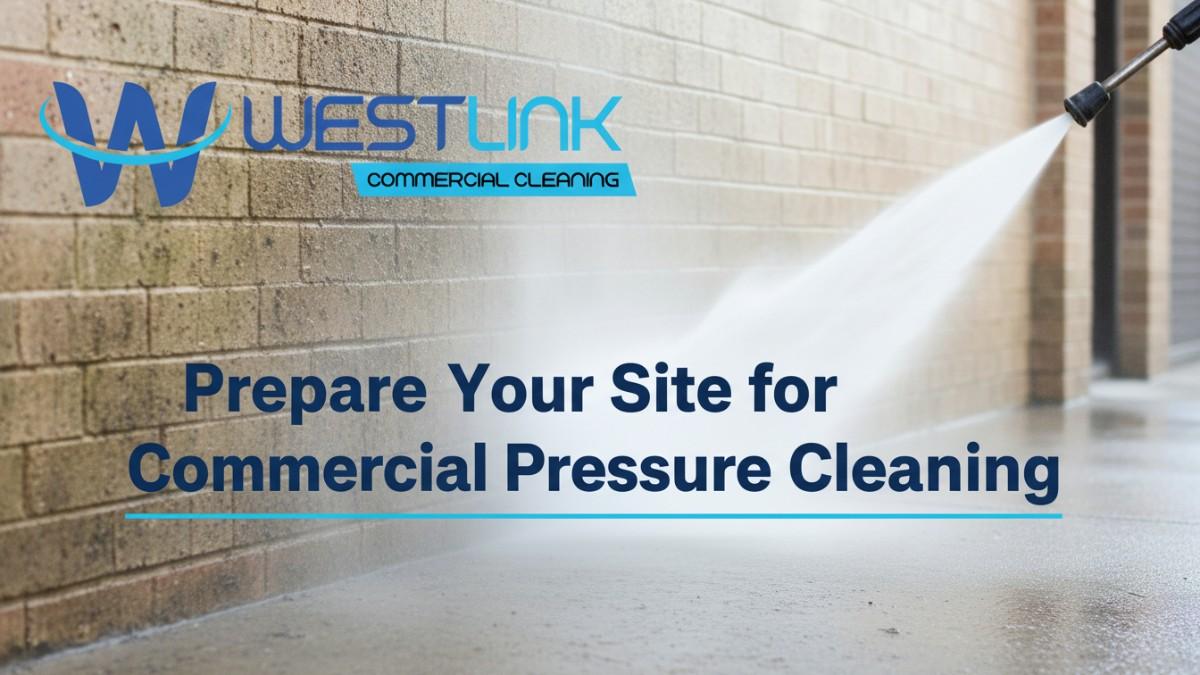 A pressure washer nozzle sprays high-pressure water onto a brick wall and concrete surface, removing dirt and grime in a bright stream.