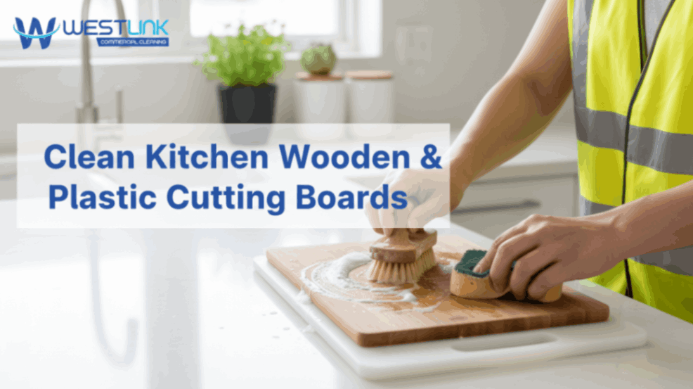 Cleaning wooden and plastic cutting boards in a kitchen.