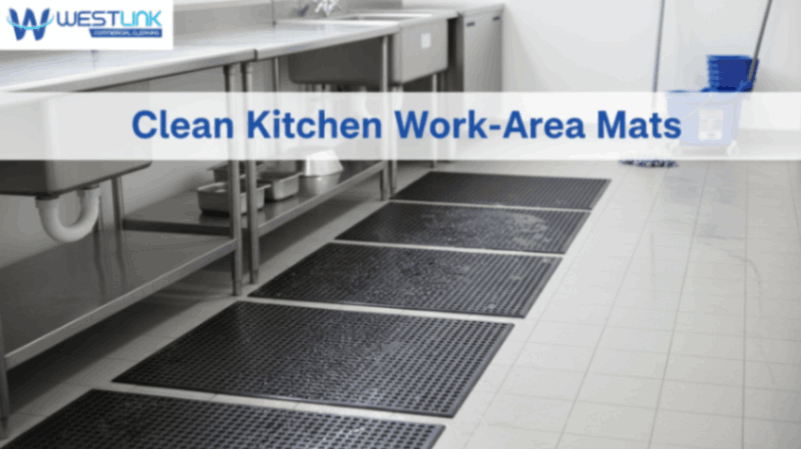 Freshly cleaned non-slip work-area mats on a commercial kitchen floor.