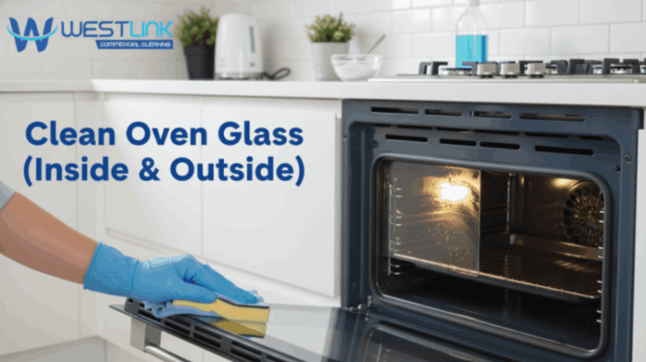 Person cleaning both the inside and outside glass of a kitchen oven using a microfiber cloth.