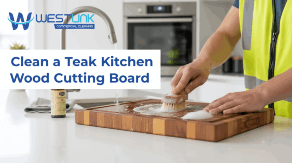 Cleaning a teak wood cutting board in a kitchen.