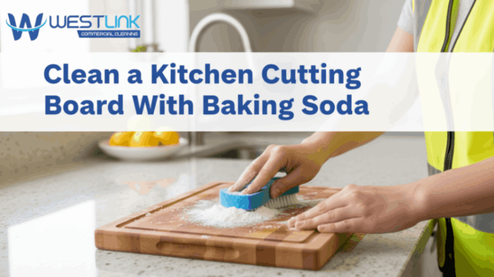 Cleaning a kitchen cutting board using baking soda and a sponge.