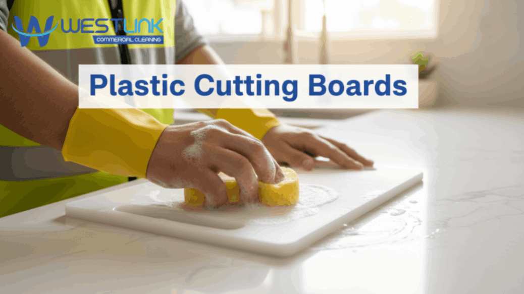 Cleaning a plastic cutting board in a kitchen.