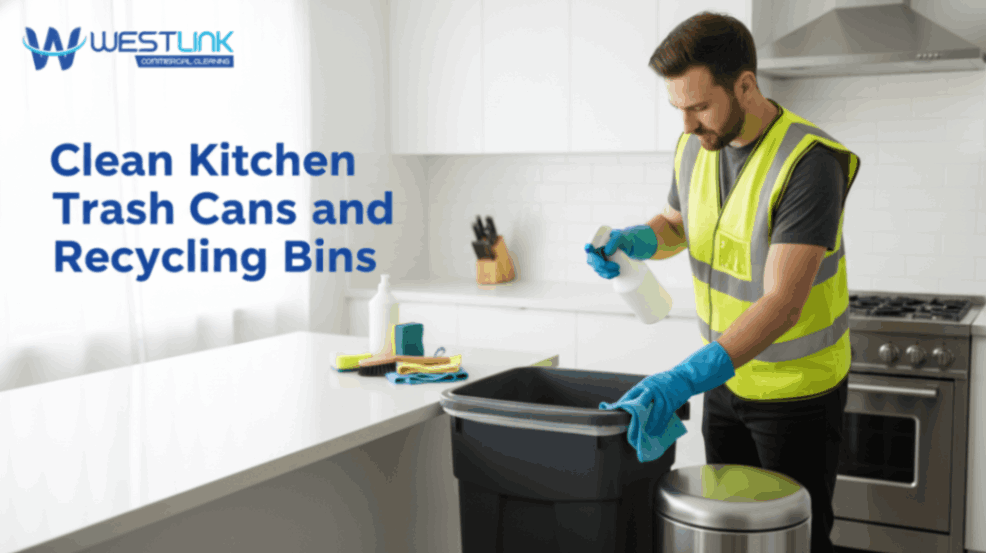 Cleaning a kitchen trash can and recycling bin using cloth and cleaning spray.