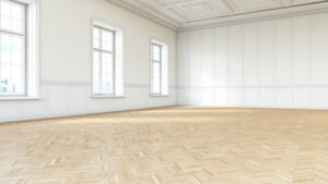 Professional cleaner restoring historic timber flooring