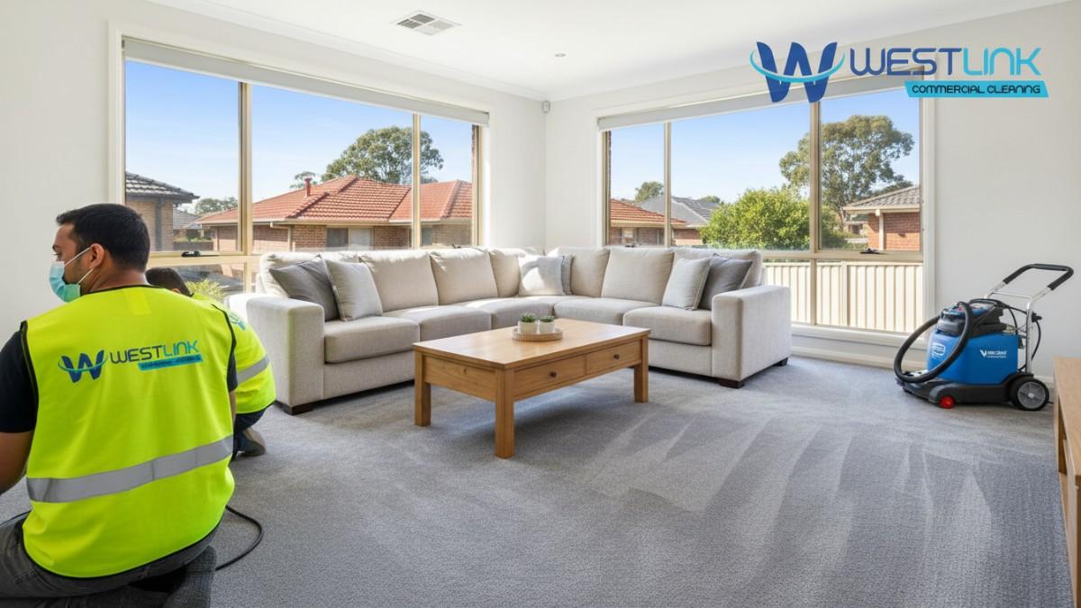 A clean living room in a Ryde, Sydney home, with gray carpets restored, furniture arranged, and natural light from windows.