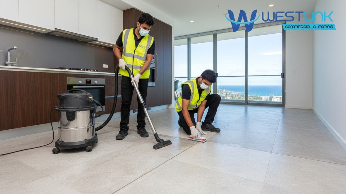 Experts cleaning kitchen tiles in a Manly apartment, Sydney, demonstrating stain removal and protective sealing.