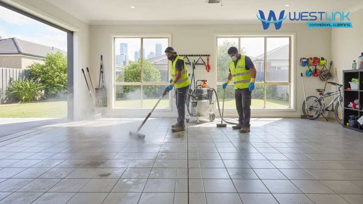 Team performing steam cleaning on tiled garage floor in a Parramatta suburban home.