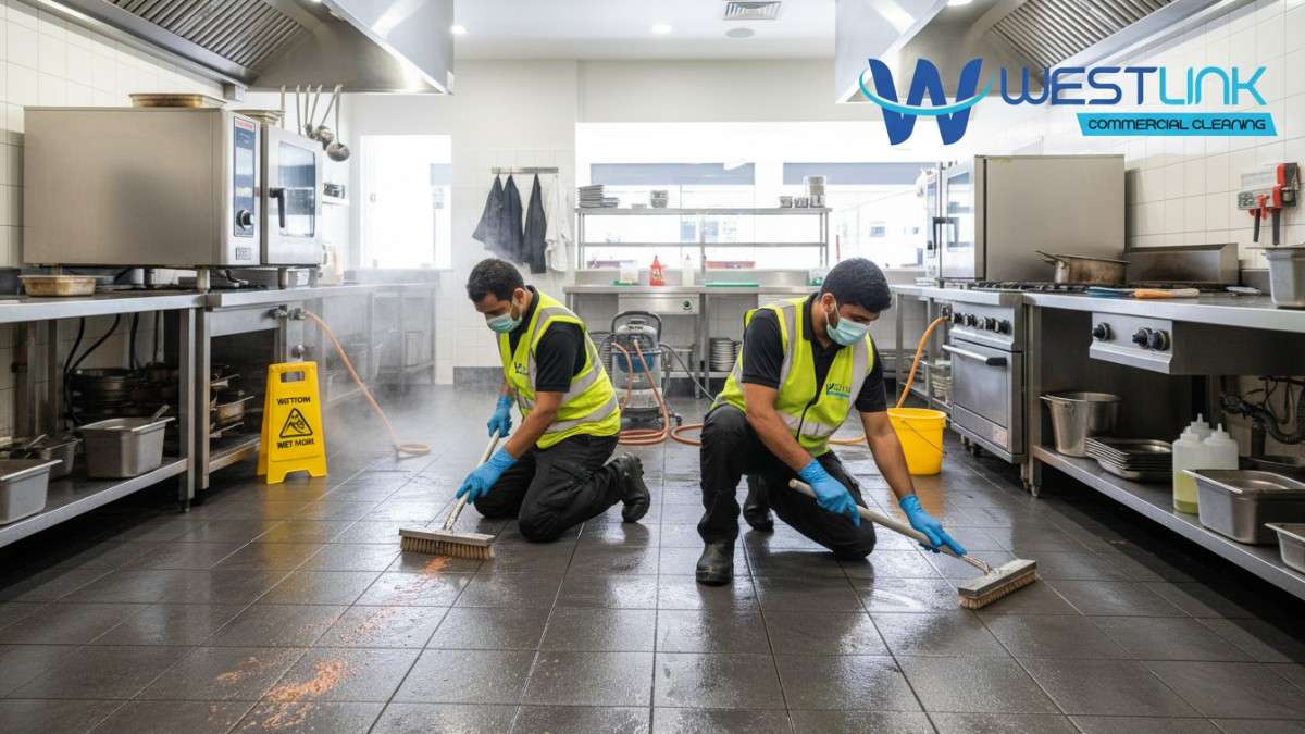 Technicians cleaning and restoring kitchen tiles in a lively restaurant in Surry Hills, Sydney, emphasizing hygiene and shine.