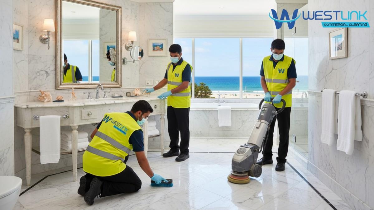 Photo of housekeeping staff polishing marble floors in a hotel bathroom, Bondi, Sydney.