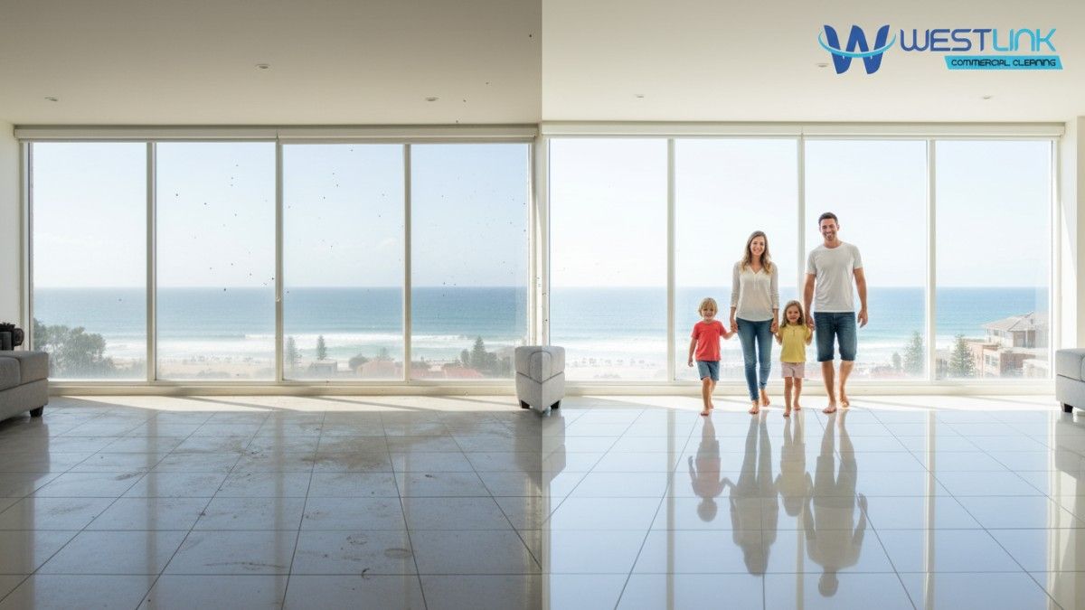 A family of four walking inside a bright, freshly cleaned living room with large floor-to-ceiling windows overlooking the Bondi Beach, Sydney.